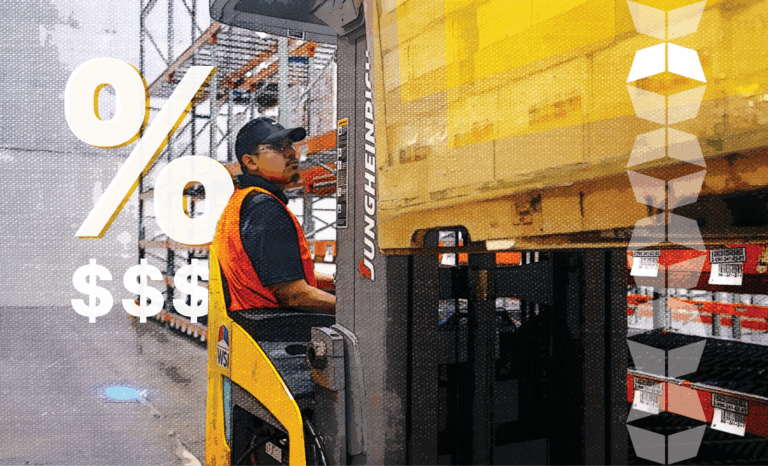 Man in warehouse using machinery to handle inventory, representing the inventory carrying costs involved in warehousing