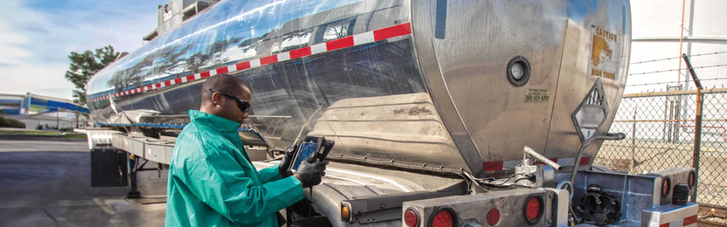 worker transferring chemicals in truck