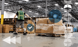 man in warehouse pulling a pallet of boxes next to storage and more boxes, representing warehouse receiving best practices for fulfillment success