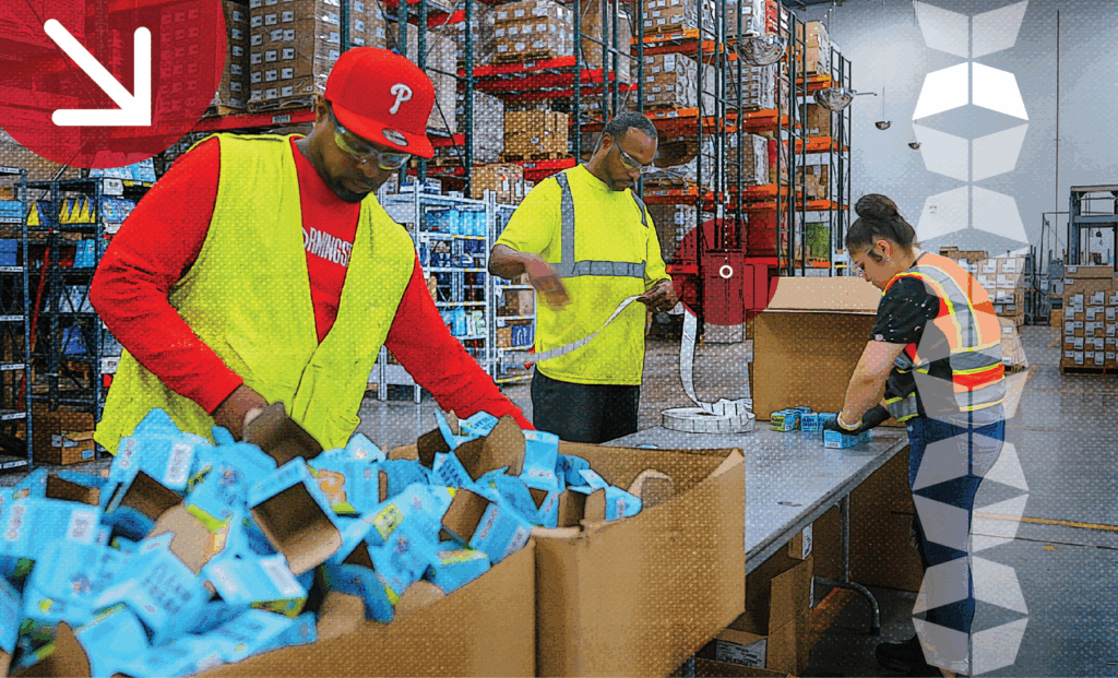 Three warehouse workers seamlessly fulfilling orders, representing the importance of labor management in warehousing and fulfillment