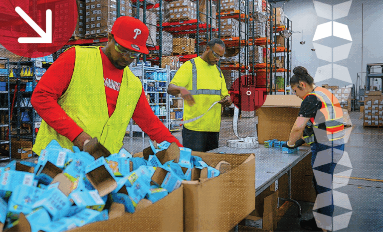 Three warehouse workers seamlessly fulfilling orders, representing the importance of labor management in warehousing and fulfillment