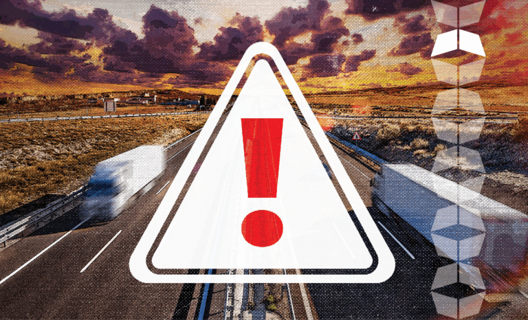 trucks on highway with sign with exclamation point overlay, reflecting the rising threat of freight fraud