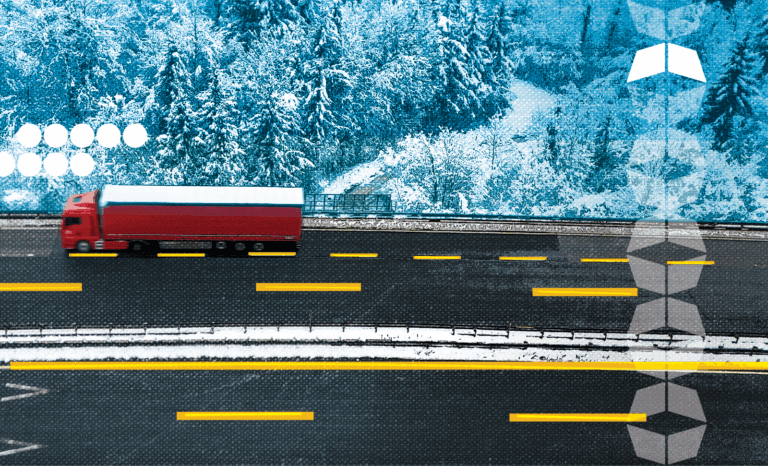 truck driving through snowy landscape, representing the challenges of winter logistics and how to prepare for winter logistics success