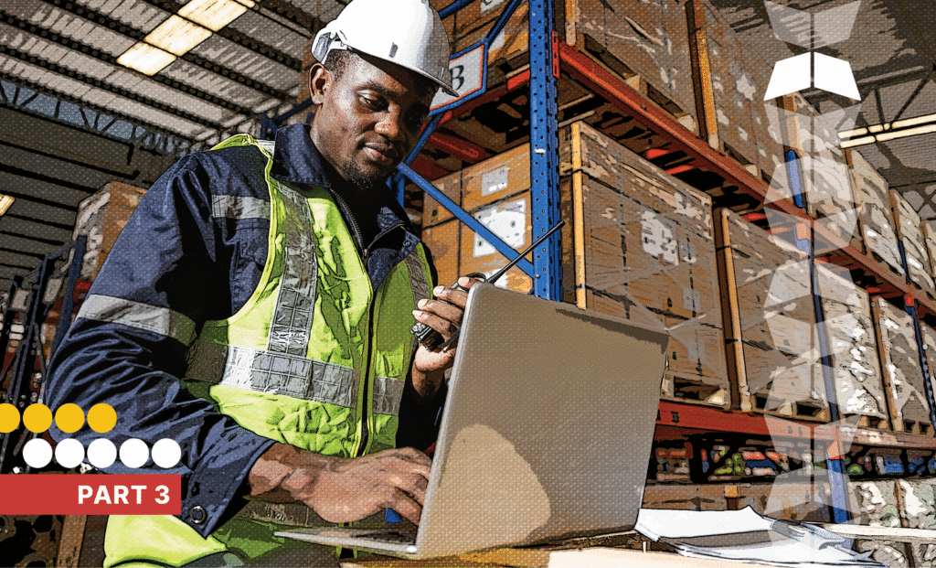 Warehouse worker in warehouse with laptop, representing the importance of a transition framework and team alignment when starting with a new manufacturing 3PL