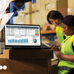 Workers in warehouse with a computer screen with data, representing supply chain visibility