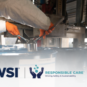 Worker handling industrial barrels safely