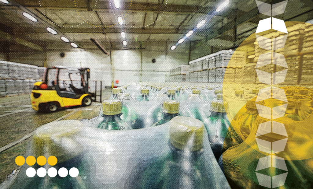 Warehouse with packaged bottles, representing downstream logistics and the end-to-end journey from production to distribution.
