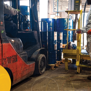 Worker in warehouse strengthening the chemical supply chain.