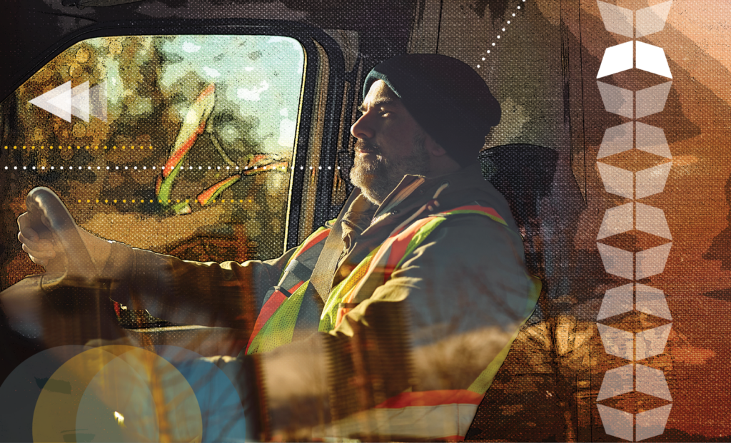 Truck driver wearing a safety vest in a cab, illustrating how non-domiciled CDL rules affect industrial freight capacity.