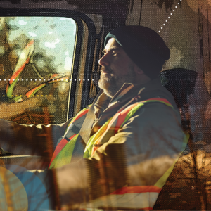 Truck driver wearing a safety vest in a cab, illustrating how non-domiciled CDL rules affect industrial freight capacity.