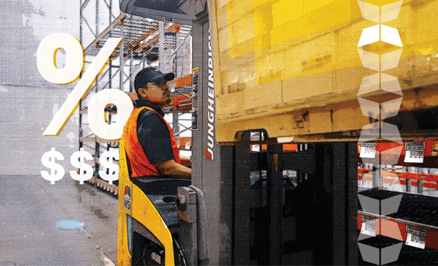 Man in warehouse using machinery to handle inventory, representing the inventory carrying costs involved in warehousing