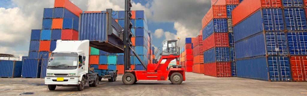 semi truck at dock with forklift loading freight trailer