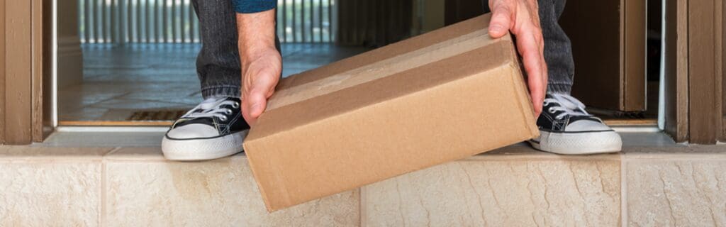 customer picking up parcel from front porch