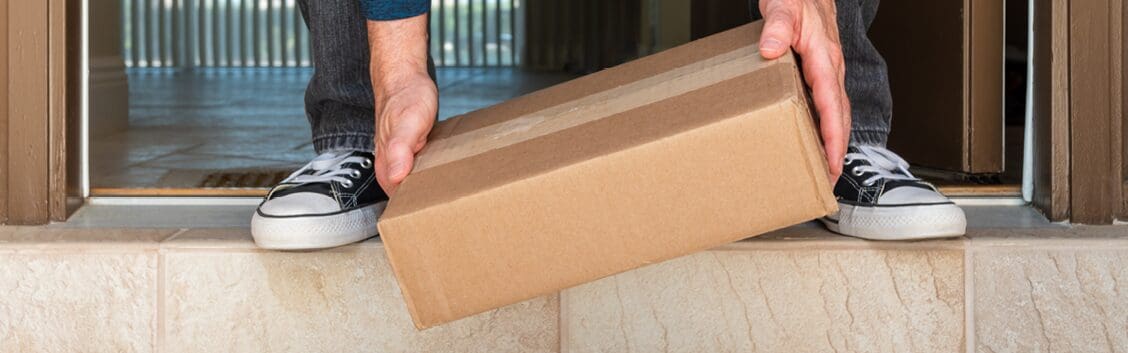 customer picking up parcel from front porch
