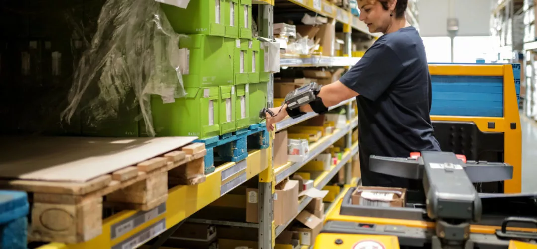 warehouse worker scanning product to fulfill orders