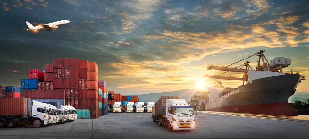 Picture of trucks with containers and cargo ship