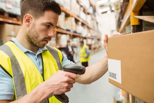warehouse worker scanning box for small parcel shipping