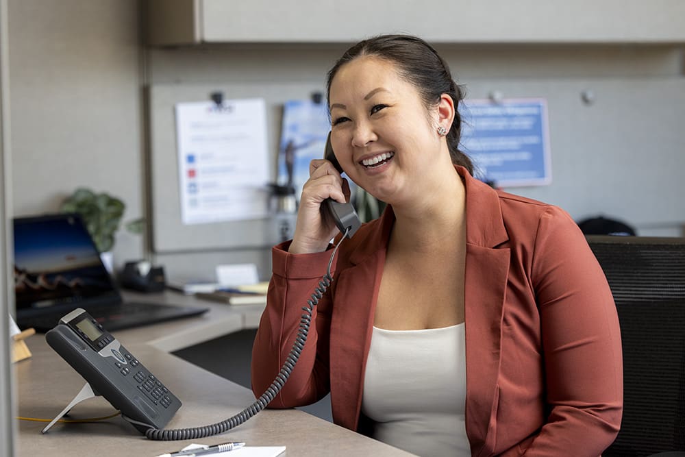 woman answering the phone at a desk