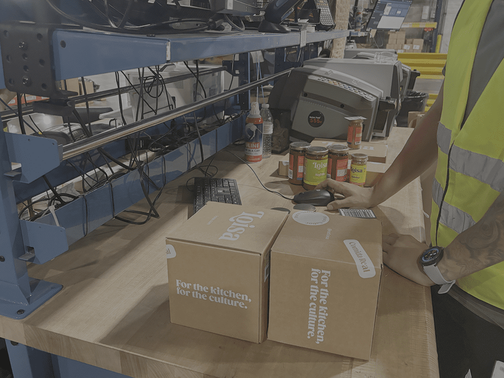 customer boxes on counter in warehouse kitting fulfillment center