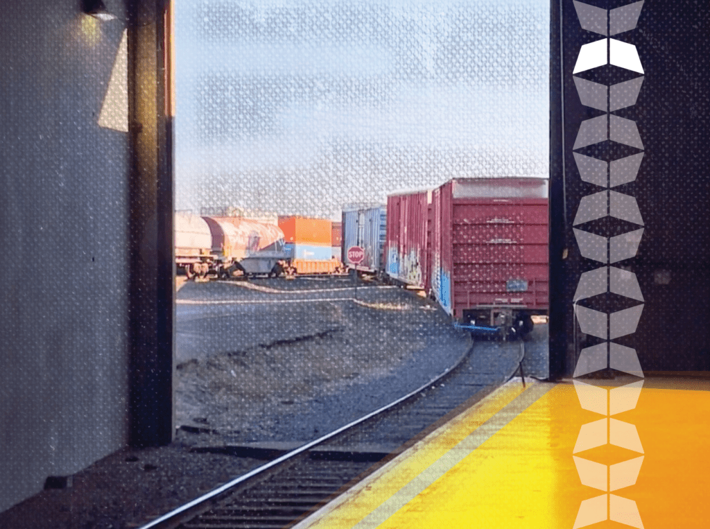 view of train cars from inside of covering