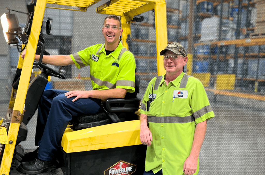 smiling warehouse workers and forklift proud of 3PL solutions