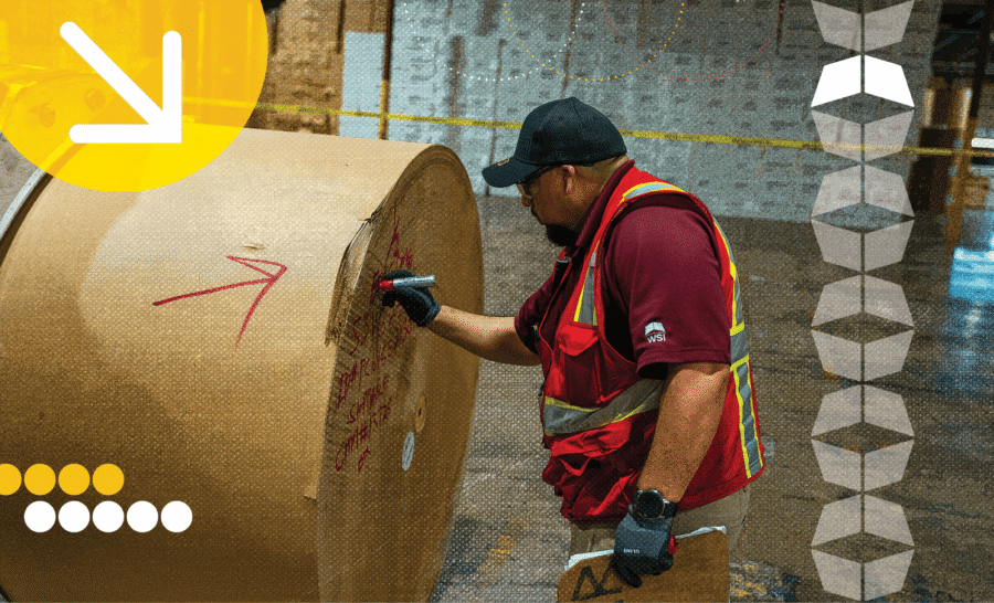 Railcar loading and unloading warehouse operator inspecting the paper roll from a loaded railcar.